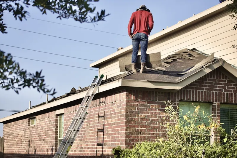 Professional roofer working on a residential roof in Ashville